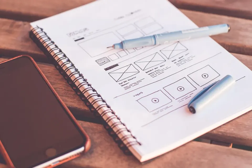 Web design plans and page layout sketches on a desk