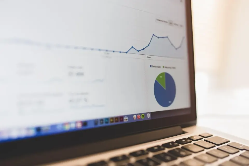 Laptop screen showing a business summary with charts and figures