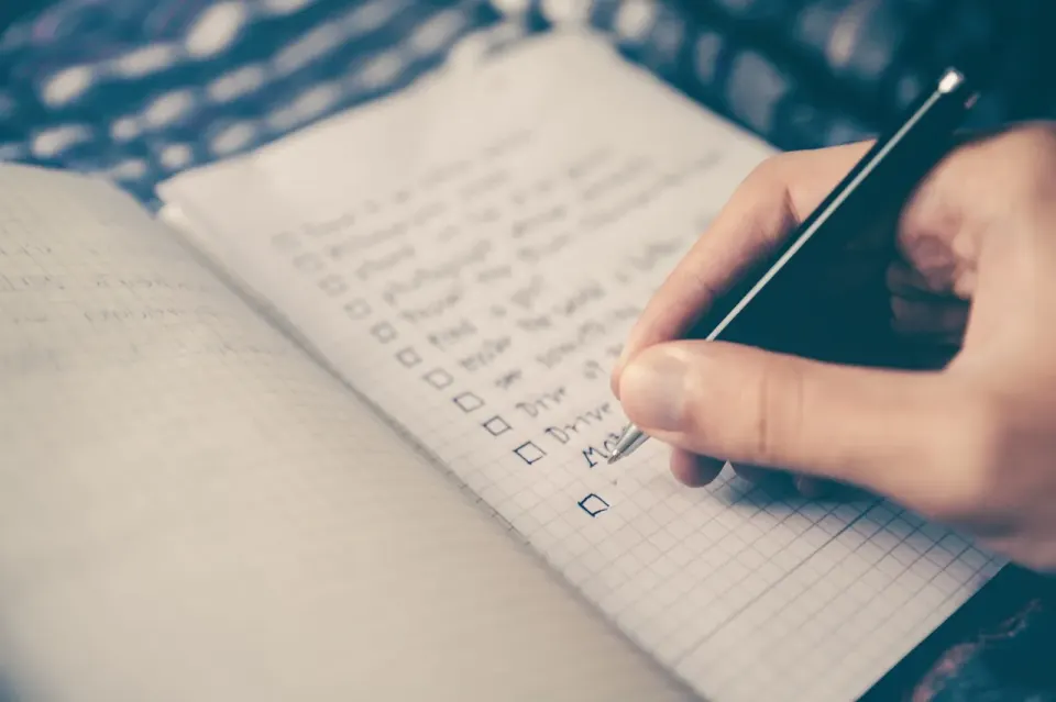 Notebook page with a handwritten checklist and ticked boxes