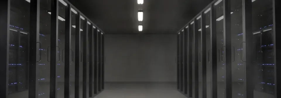 Rows of servers glowing in a dark server room